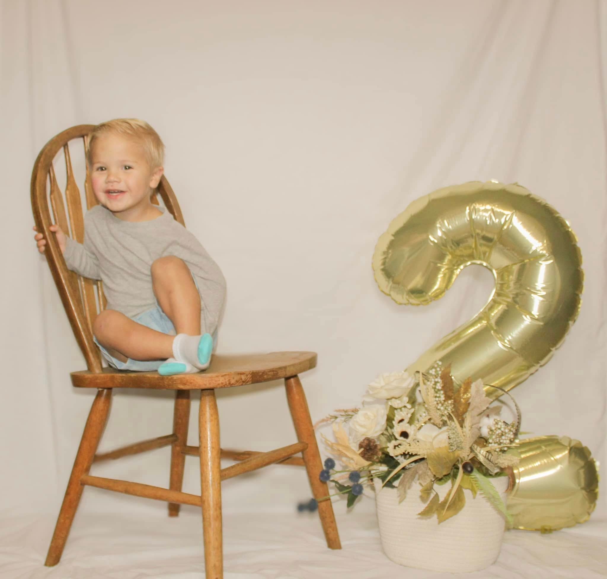 Smiling toddler celebrating turning two